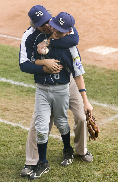 Matthew Bettencourt is congratulated by manger Mike Orlando at the end of game 4 after Pearland defeated Northwest 7-5 in a comeback victory to advance to the American Championship game.   Bettencourt's throw to third from center was good for the second out of the sixth inning to stop a Northwest rally.