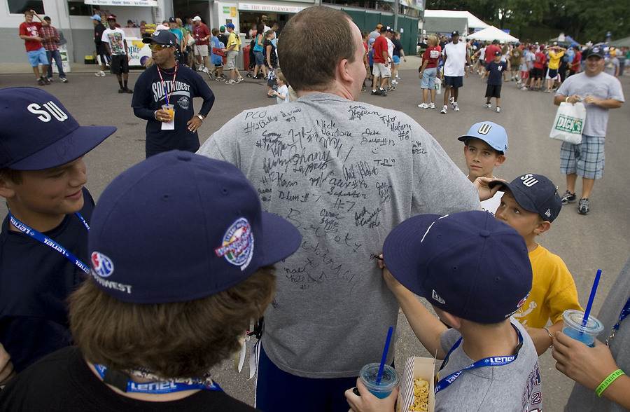 The Pearland team signs Lancaster Pennsylvania resident Justin Bandy's shirt while walking the grounds on a Sunday afternoon. Young and old fans would seek out the team in hopes of an autograph.  